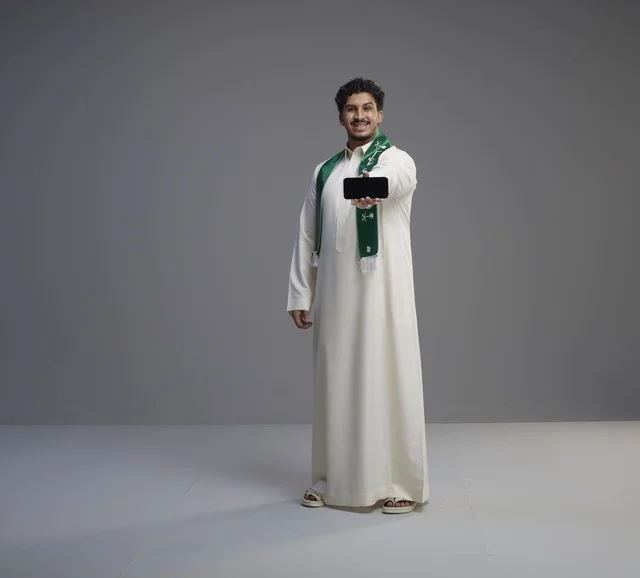 Saudi Man Holding Smartphone with Blank Horizontal Screen