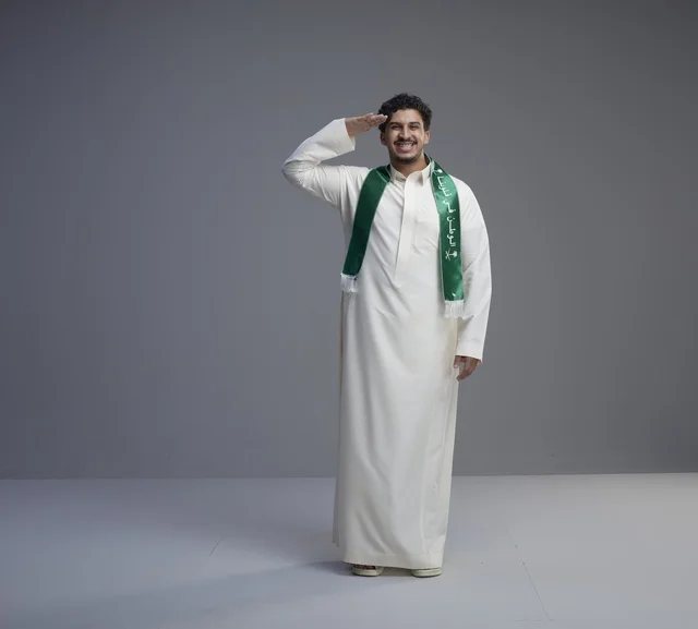 Saudi Man Saluting in National Scarf Studio Shot