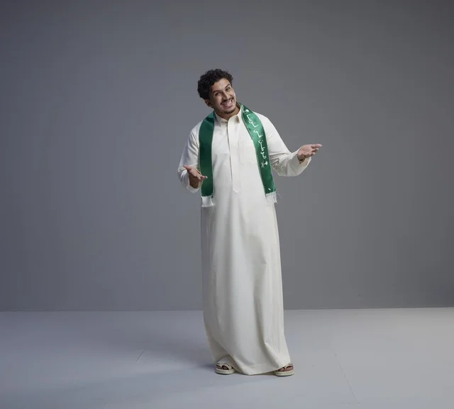 Saudi Man in National Day Scarf on Grey Background
