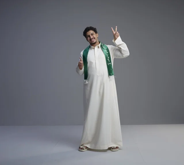 Saudi Man with National Scarf Making Victory Sign Saudi Man with National Scarf Making Victory Sign