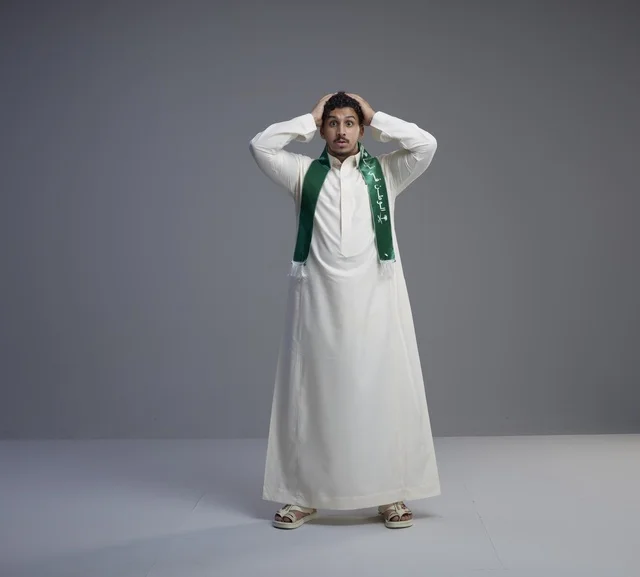 Surprised Saudi Man Wearing Green National Scarf