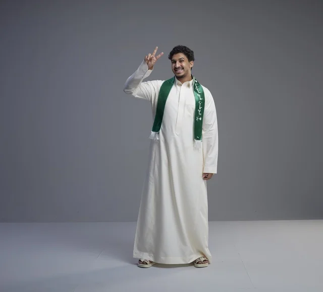 Saudi Man in Thobe with National Scarf Victory Sign