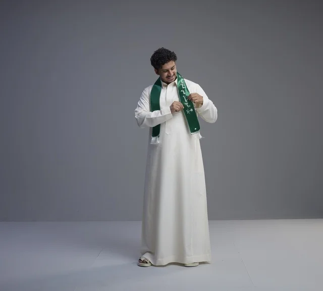 Saudi Man Wearing National Green Scarf on Grey Background