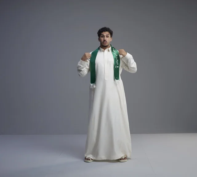 Saudi Man Wearing National Scarf on Grey Background