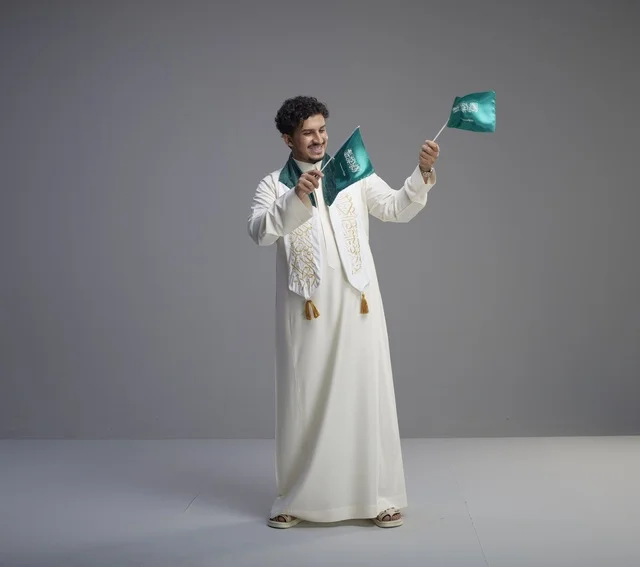 Saudi Graduate with National Flag in Studio Setting