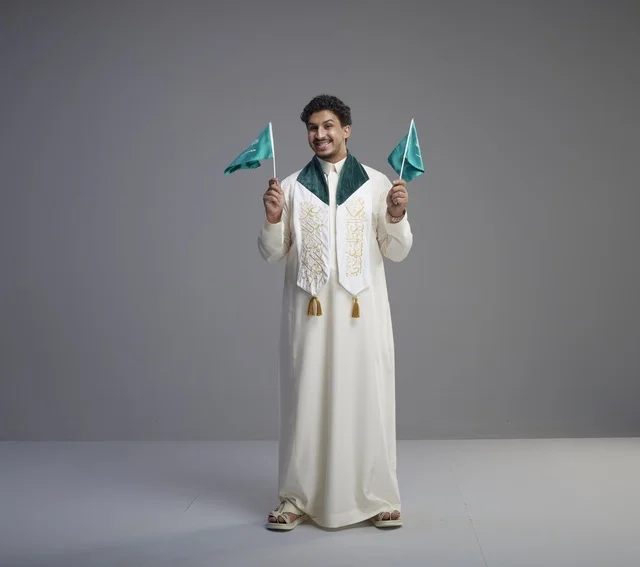 Saudi Graduate Holding National Flags in Studio