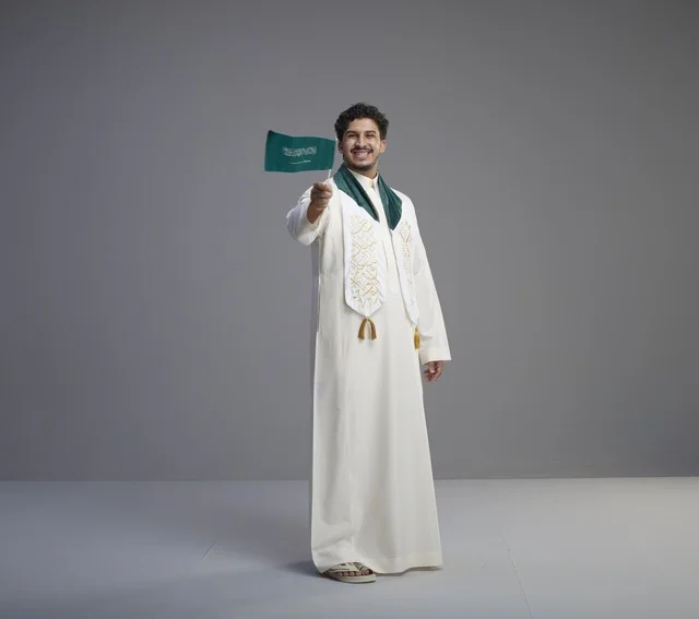 Saudi Graduate Holding National Flag in Studio