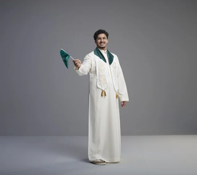 Saudi Graduate with National Flag in Studio Portrait