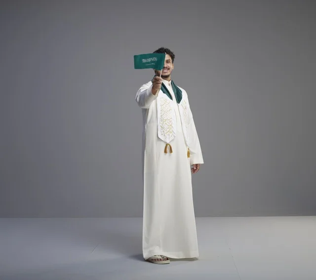 Saudi Graduate Holding National Flag in Studio