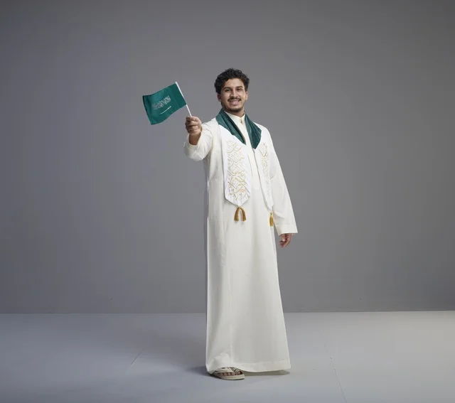 Saudi Graduate Man Holding National Flag in Studio