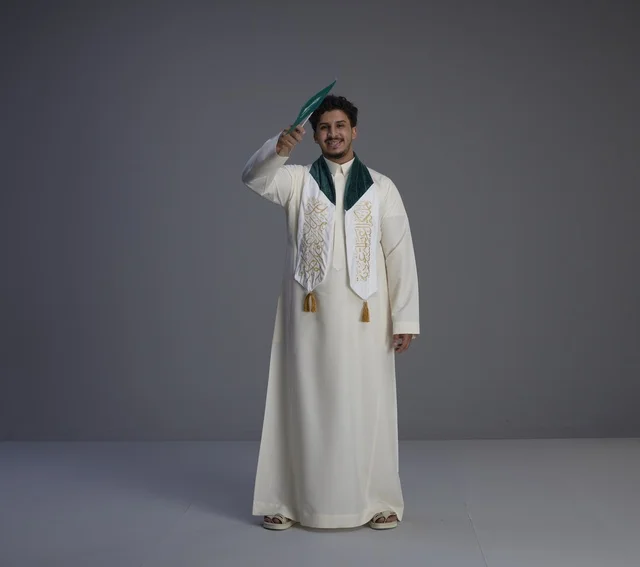 Saudi Male Graduate with National Flag in Studio Thobe