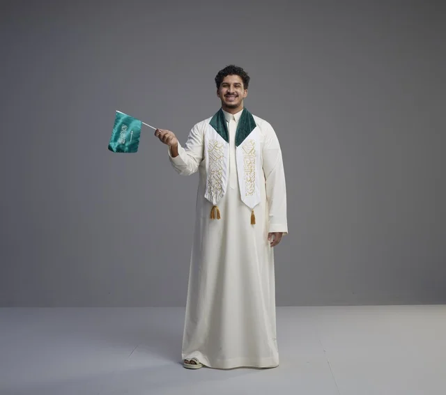 Saudi Graduate Student Holding National Flag