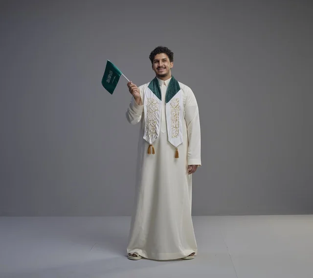 Saudi Man Graduation Celebration with National Flag Saudi Man Graduation Celebration with National Flag