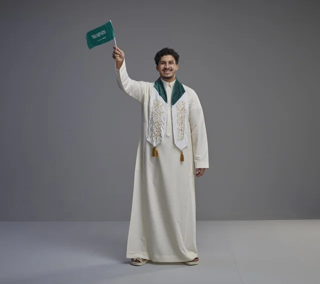 Saudi Male Graduate Holding National Flag in Studio