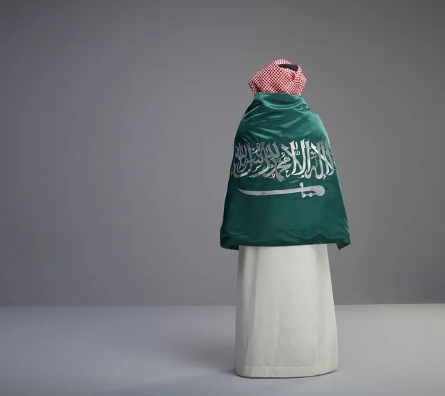 Saudi Man Wrapped in National Flag From Behind in Studio