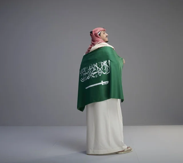 Saudi Man with National Flag on Studio Background