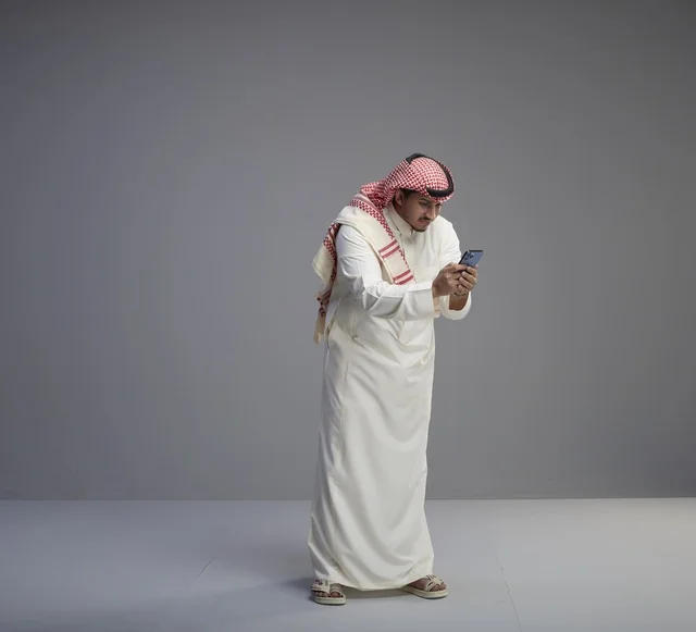 Saudi Man Using Smartphone in Studio Setting
