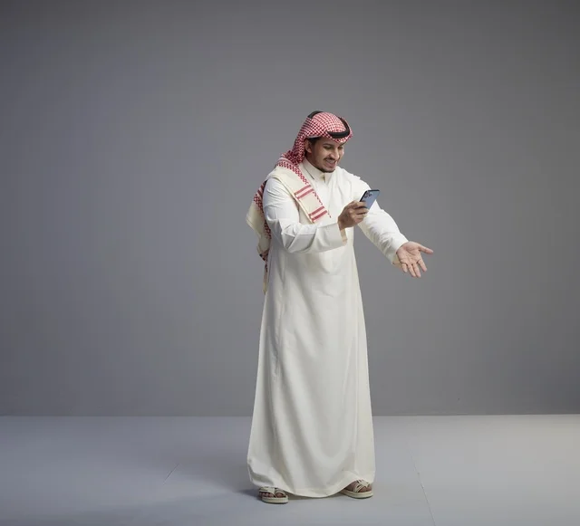 Saudi Man with Smartphone Gesturing in Studio Shot