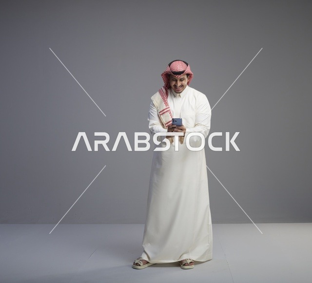 Saudi Man Using Smartphone in Traditional Thobe