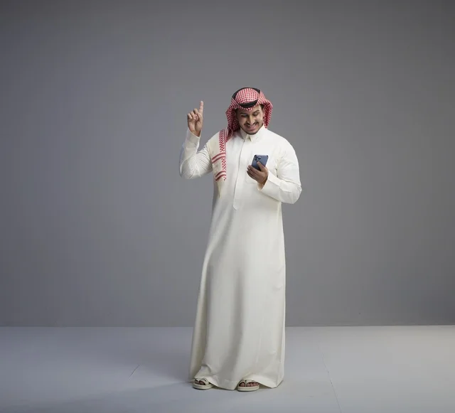 Saudi Man Using Smartphone for Messaging