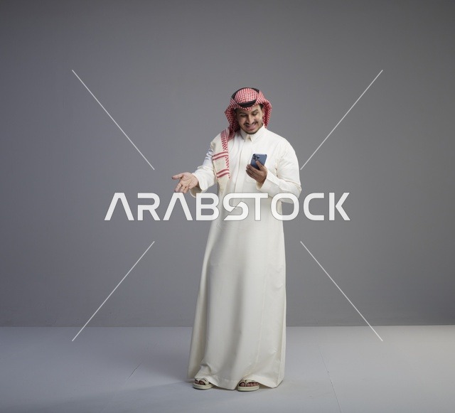 رجل سعودي يستخدم الهاتف الذكي في الاستوديو