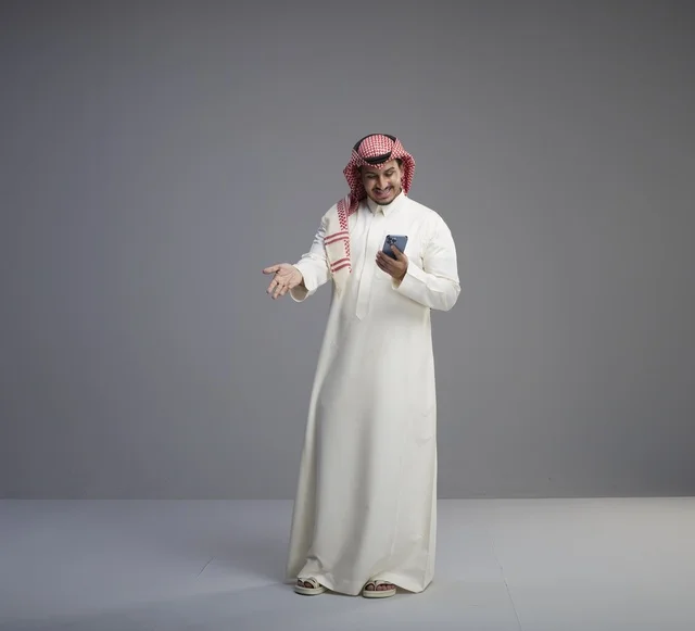 Saudi Man Using Smartphone in Studio Setting