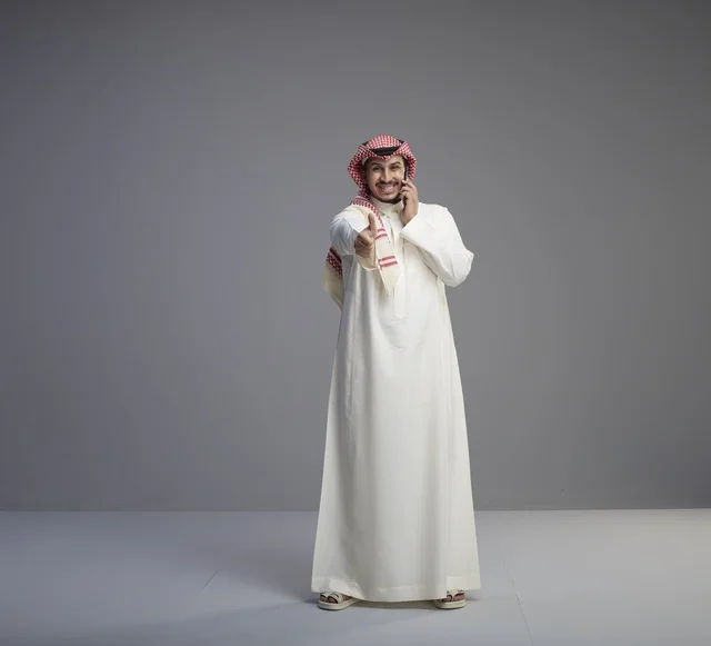 Saudi Man Talking on Smartphone with Thumbs Up