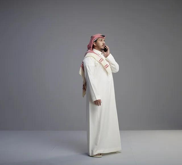 Saudi Man Talking on Smartphone in Studio Setting