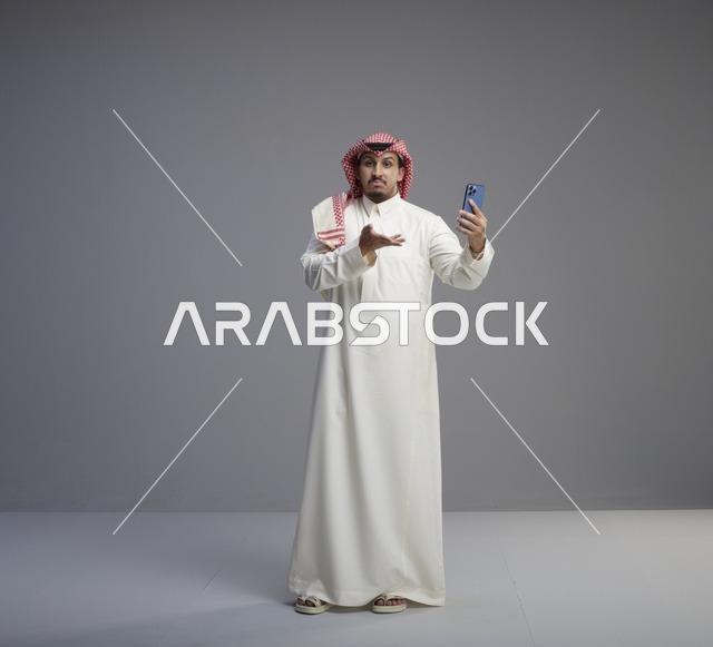 Saudi Man Using Smartphone with Gesture in Studio