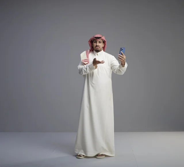 Saudi Man Using Smartphone with Gesture in Studio