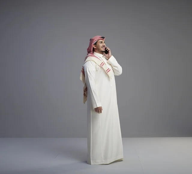 Saudi Man Talking on Smartphone in Studio Background