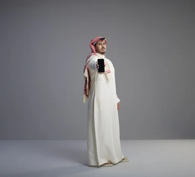 Saudi Man Holding Smartphone Mockup in Studio