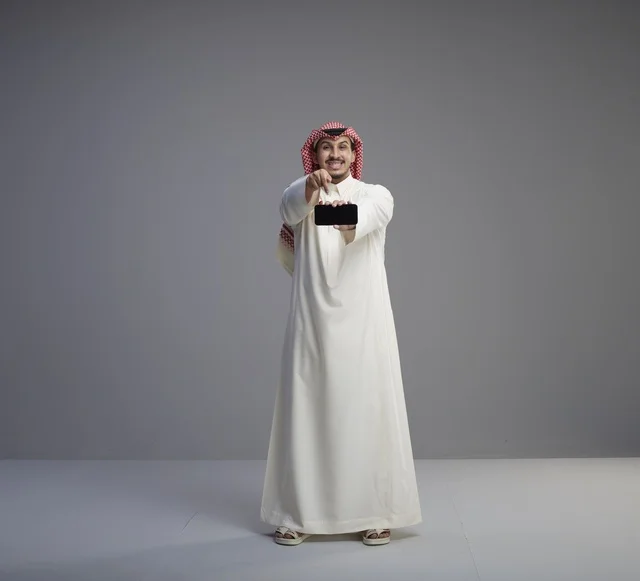 Saudi Man Holding Horizontal Smartphone Mockup