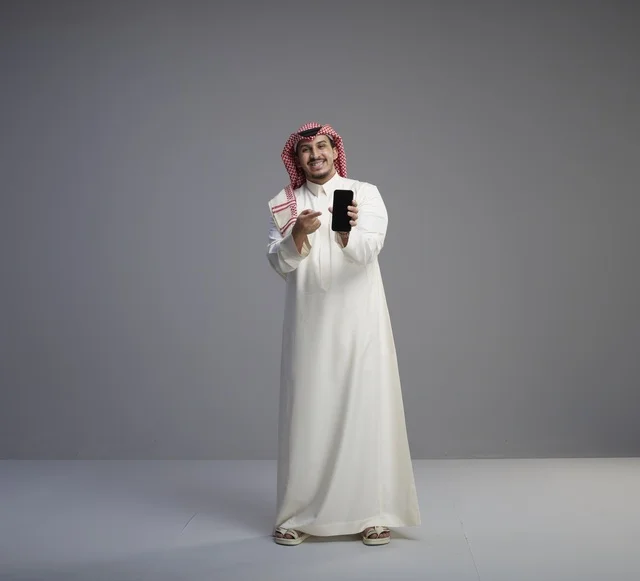 Saudi Man Holding Smartphone Mockup on Grey Background