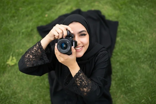 Saudi Woman Photographer in Black Abaya Holding Camera