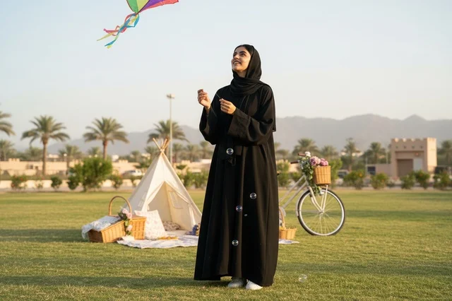 Emirati Woman Flying Kite in Outdoor Park