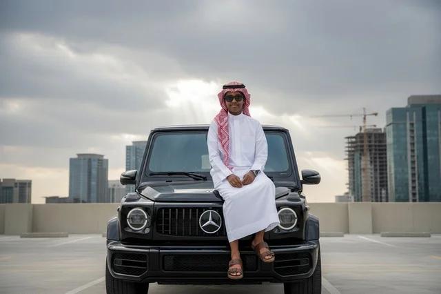 Saudi Man with Luxury SUV and City Skyline Saudi Man with Luxury SUV and City Skyline