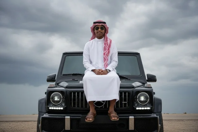Saudi Man in Traditional Thobe on Luxury Black SUV