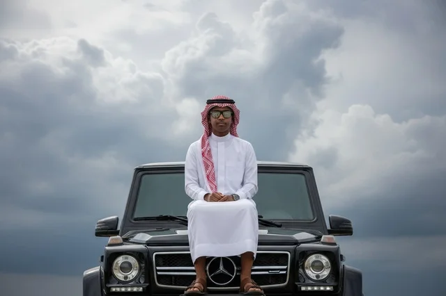 Saudi Man with Luxury SUV under Cloudy Sky Saudi Man with Luxury SUV under Cloudy Sky