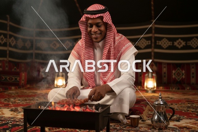 رجل سعودي يشوي اللحم داخل خيمة تراثية