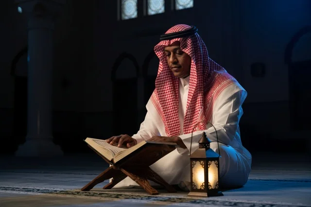 Saudi Man Reading Quran in Mosque with Lantern