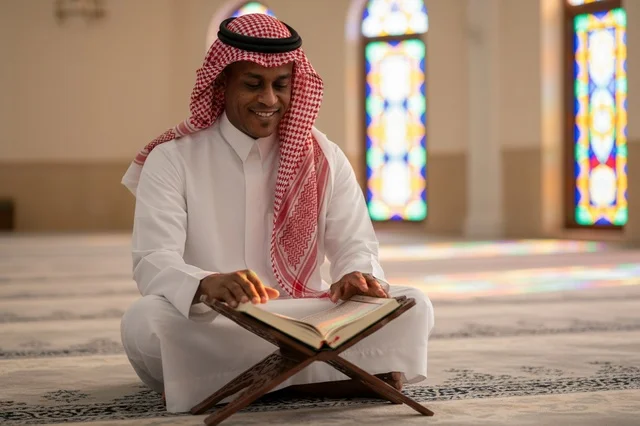 Saudi Man Reading Quran in Mosque Interior