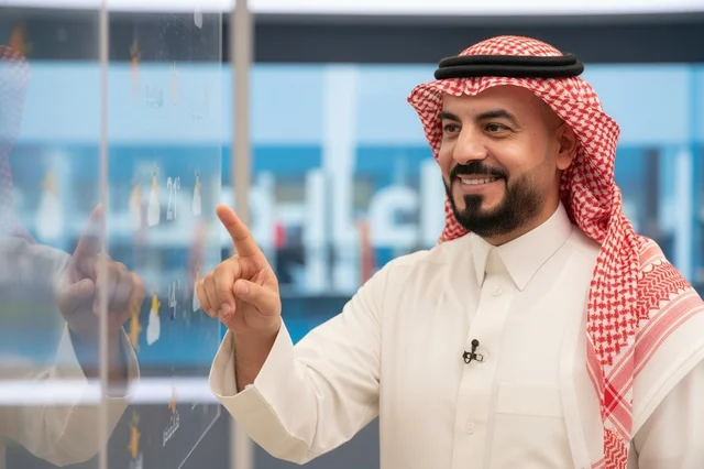 Saudi Man in Traditional Dress Pointing at Screen
