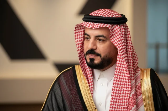 Saudi Man in Traditional Black Bisht and Red Shemagh