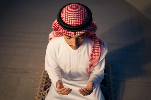 Saudi Man in Traditional Dress Performing Prayer