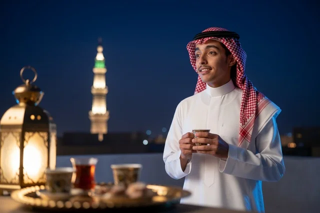 Saudi Man in Thobe with Ramadan Lantern at Night