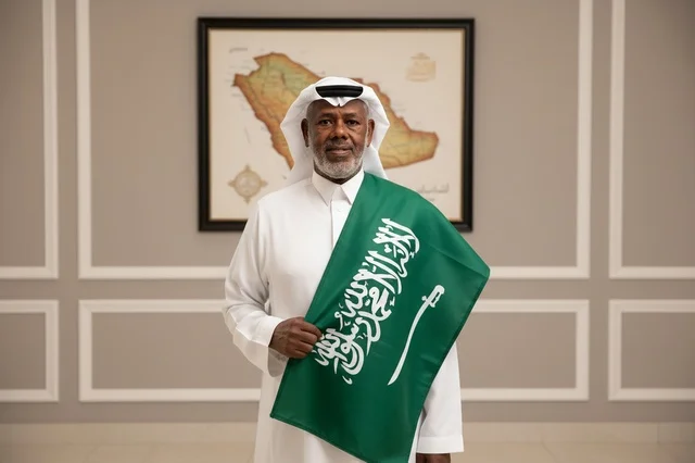 Saudi Man in Traditional Dress with National Flag