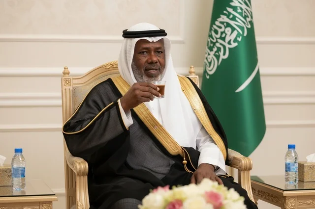 Saudi Man in Black Bisht Holding Arabic Coffee