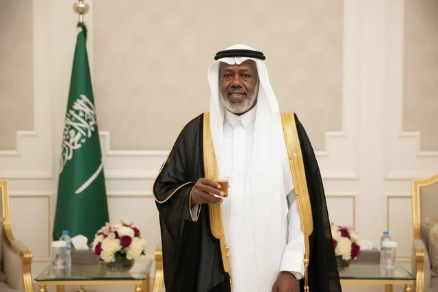 Saudi Man in Traditional Bisht Holding Coffee