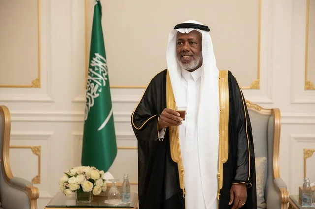 Saudi Man in Traditional Bisht Holding Coffee